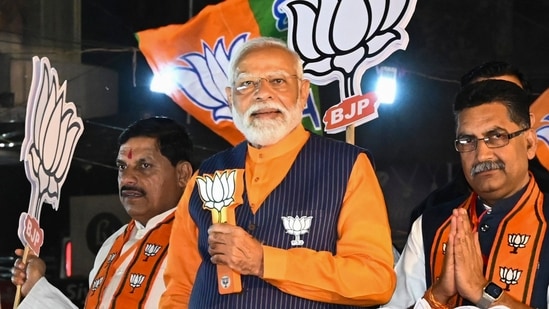 Prime Minister Narendra Modi with Madhya Pradesh Chief Minister Mohan Yadav and BJP candidate Ashish Dubey during a road show ahead of Lok Sabha elections, in Jabalpur(PTI)