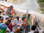 Security personnel use water cannon to disperse BJP workers protesting against AAP convener and Delhi CM Arvind Kejriwal, outside AAP office in New Delhi.(PTI)