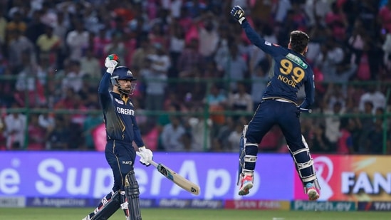 Gujarat Titans' Rashid Khan, left, and teammate Noor Ahmad celebrate their team's victory during the Indian Premier League cricket match against Rajasthan Royals in Jaipur.(AP)