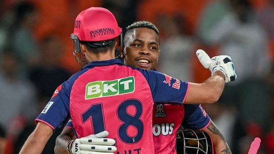 Rajasthan Royals' Shimron Hetmyer and his teammate Trent Boult (front) celebrate after winning vs Punjab Kings(AFP)