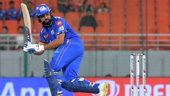 Mumbai Indians' Rohit Sharma watches the ball after playing a shot.(AFP)