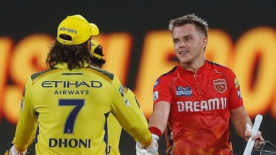 Punjab Kings' captain Sam Curran shakes hands with Chennai Super Kings' MS Dhoni after Punjab Kings won the IPL match(AP)