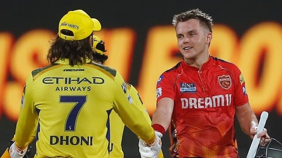 Punjab Kings' captain Sam Curran shakes hands with Chennai Super Kings' MS Dhoni after Punjab Kings won the Indian Premier League cricket match(AP)