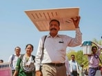 Polling officials carrying election material leave for their duty during in a hot day in Bhopal, Madhya Pradesh.(PTI)