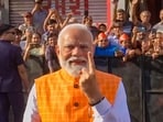 The PM, who arrived in Ahmedabad on Monday night, cast his vote in the polling booth after getting his finger inked. (PTI)