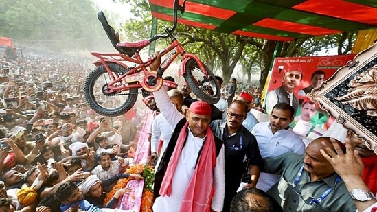 Samajwadi Party (SP) Chief Akhilesh Yadav holds a bicycle during a rally, in Hardoi, Uttar Pradesh.(ANI)