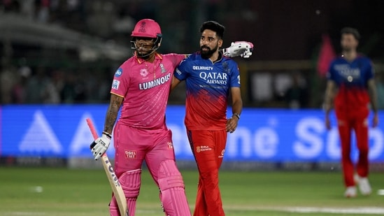 Rajasthan Royals' Shimron Hetmyer (L) and Royal Challengers Bengaluru's Mohammed Siraj (C) look on at the end of the Indian Premier League (IPL) Twenty20 cricket match between Rajasthan Royals and Royal Challengers Bengaluru (AFP)