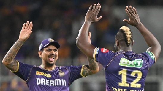 Kolkata Knight Riders' Andre Russell (R) celebrates with teammate Sunil Narine after taking a wicket.(AFP)