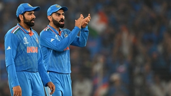 India's captain Rohit Sharma (L) and teammate Virat Kohli celebrate after the dismissal of Australia's Mitchell Marsh (AFP)