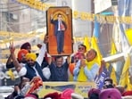 Delhi Chief Minister and Aam Aadmi Party (AAP) National Convener Arvind Kejriwal holds up a portrait of Dr. BR Ambedkar along with Punjab CM Bhagwant Mann during a roadshow in Patiala, Punjab.(ANI)