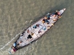 Polling officials travel by boat to their polling booths ahead of voting in the seventh and final phase of Lok Sabha elections in North 24 Parganas district of West Bengal.(PTI)