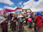 Women celebrate after casting their votes at the world's highest polling station located at an altitude of 15,256 feet in Tashigang, Lahaul and Spiti, Himachal Pradesh.(Arun Sharma / PTI)