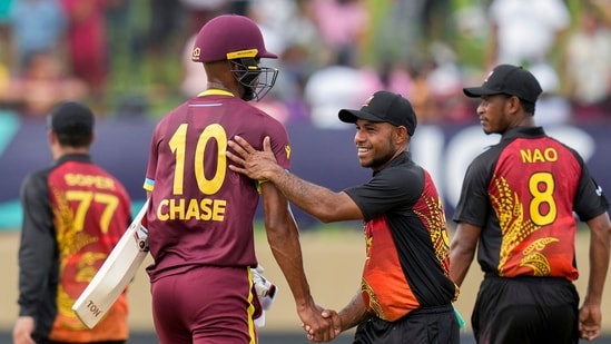 Papua New Guinea's Sese Bau congratulates West Indies' batsman Roston Chase (AP)