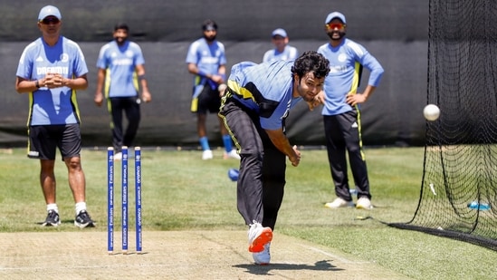 Shivam Dube bowls during a practice session as coach Rahul Dravid and teammates look on.(ANI)