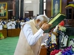 Prime Minister Narendra Modi pays respects to the Constitution of India as he attends the NDA Parliamentary Party meeting at Samvidhan Sadan, in New Delhi, Friday(PTI)