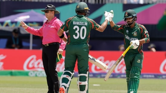 Bangladesh's Tawhid Hridoy, right, celebrates with batting partner Mahmudullah Riyad(AP)