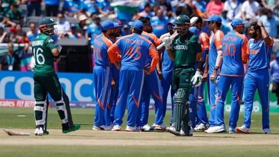 Pakistan's captain Babar Azam , center in green, walks off the field after he was dismissed by India's Jasprit Bumrah(AP)