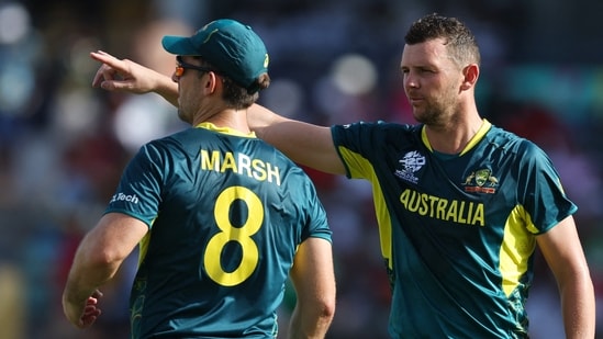 Australia's Josh Hazlewood and Mitchell Marsh talks during play(REUTERS)