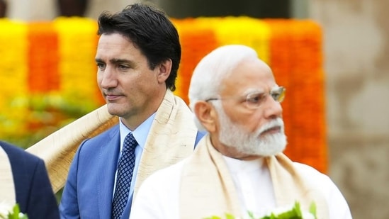 Canada's Prime Minister Justin Trudeau, left, walks past India's Prime Minister Narendra Modi (AP/File)