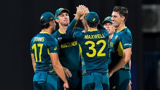 Australia's captain Mitchell Marsh (2L) and Australia's Pat Cummins celebrate the dismissal of Namibia's Jan Frylinck during the ICC men's Twenty20 World Cup 2024 group B cricket match(AFP)