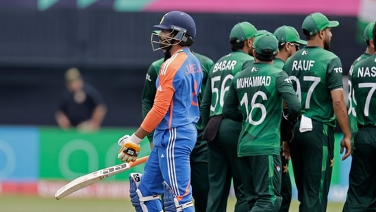 India's Ravindra Jadeja, left, walks off the field after losing his wicket against Pakistan(AP)