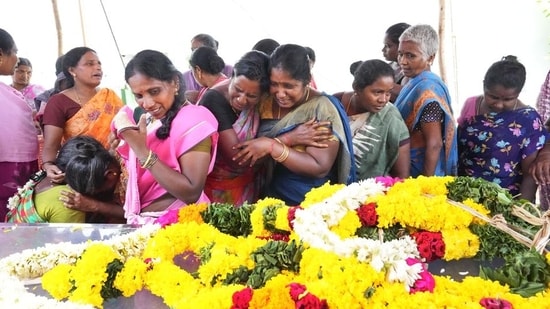 Relatives mourn near the mortal remains of people who died after consuming spurious liquor in Kallakurichi in Tamil Nadu on Friday. (PTI)(HT_PRINT)
