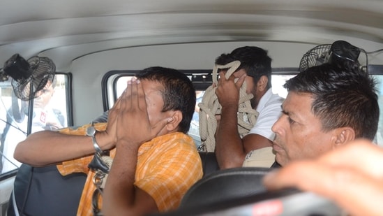 Patna, Bihar, India -June .23, 2024:Police taking the accused of NEET paper leak case, arrested by EOU from Deoghar, to the court after medical checkup from Shastri Nagar LNJP hospital in Patna, Bihar, India, Sunday,23, 2024.(Photo by Santosh Kumar/ Hindustan Times)