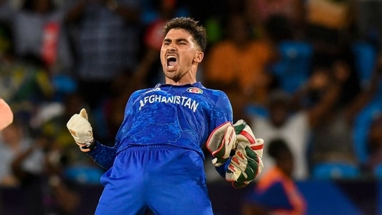 Afghanistan's Rahmanullah Gurbaz (R) celebrate his team's win of the ICC men's Twenty20 World Cup 2024 Super Eight cricket match against Australia.(AFP)