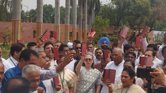 Opposition leaders protest outside Parliament with copies of Constitution