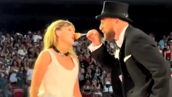 Travis Kelce brushes Taylor's nose for a special performance at the Eras Tour.