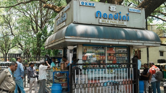 Customers at a Nandini milk shop in Bengaluru.(PTI)