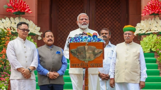 Prime Minister Narendra Modi along with union parliamentary affairs minister Kiren Rijiju and others outside the Parliament. (PTI file photo)