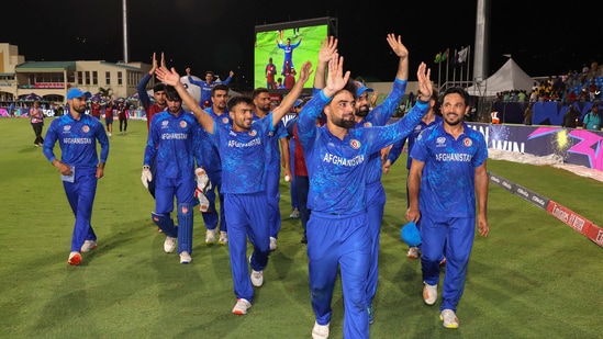 Afghanistan's captain Rashid Khan with teammates acknowledges fans after Afghanistan won the ICC Men's T20 World Cup cricket match against Bangladesh, at Arnos Vale Ground, Kingstown, Saint Vincent and the Grenadines
