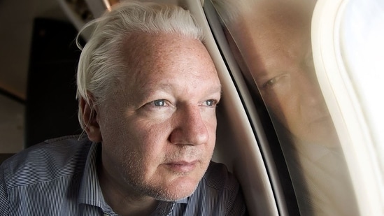 WikiLeaks founder Julian Assange looking out of the window as his plane from London approaches Bangkok for a layover at Don Mueang International Airport in the Thai capital. (AFP)