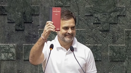 Congress MP Rahul Gandhi shows a copy of the Constitution of India while taking oath as a Member of the 18th Lok Sabha during its second day, at the Parliament, in New Delhi on Monday.(ANI )