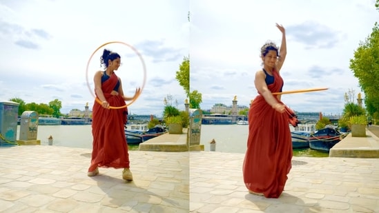 Indian artist juggling a hula hoop in a saree in Paris. (Instagram/@eshnakutty)