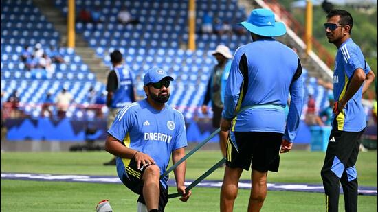 India's Yuzvendra Chahal (R) and India's captain Rohit Sharma (L) practice prior the ICC men's Twenty20 World Cup 2024 Super Eight cricket match between Australia and India at Daren Sammy National Cricket Stadium in Gros Islet, Saint Lucia on June 24, 2024. (Photo by CHANDAN KHANNA / AFP) (AFP)