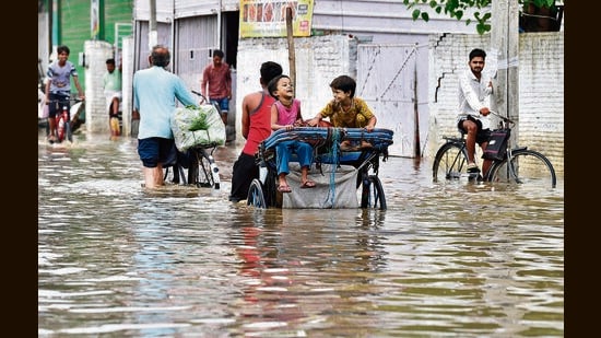 Amid waterlogging at the main roads across the city, the locals were seen struggling to complete their daily chores as life came to a standstill in Ludhiana on Thursday. (Gurpreet Singh/HT)