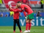 During Portugal's match against Turkey, a young child got past security and ran onto the pitch tot take a selfie with his idol Cristiano Ronaldo and the legend agreed with a smile.(AP)