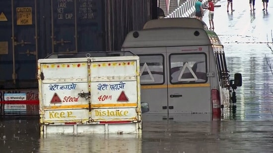 Vehicles partially submerged in the waterlogged underpass at Moolchand following heavy rainfall, in New Delhi on Friday. (ANI)