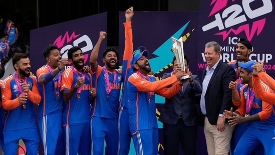 India's captain Rohit Sharma, center, reacts as he receives the winners trophy after defeating South Africa in the ICC Men's T20 World Cup final cricket match at Kensington Oval in Bridgetown, Barbados(PTI)