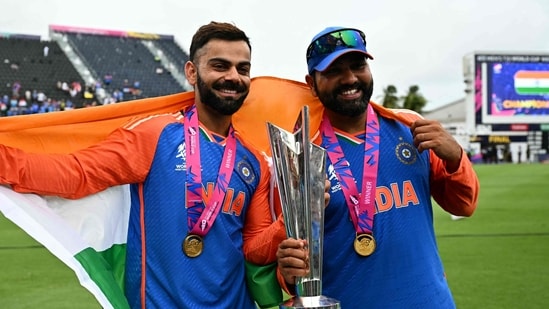 India's Virat Kohli and captain Rohit Sharma celebrate with the trophy after winning the ICC men's Twenty20 World Cup 2024 final(AFP)