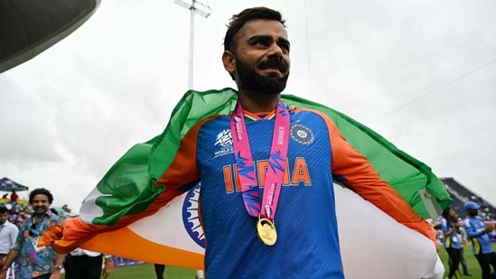 India's Virat Kohli celebrates with the trophy.(AFP)