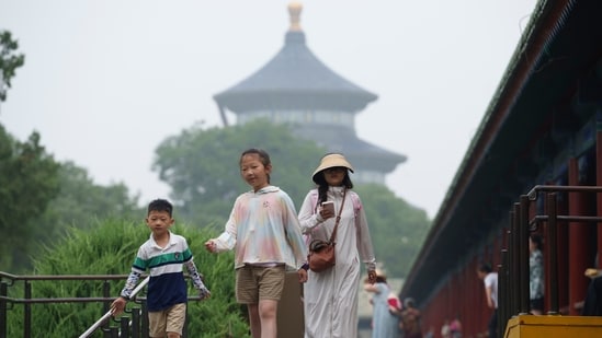 Children's walk at the Temple of Heaven in Beijing, China. The summer school holidays have begun in China, and millions of tourists are expected to flood into the city during this period. Beijing eases mainland China entry with new five-year visa for Hong Kong, Macau residents (AP Photo/Vincent Thian)