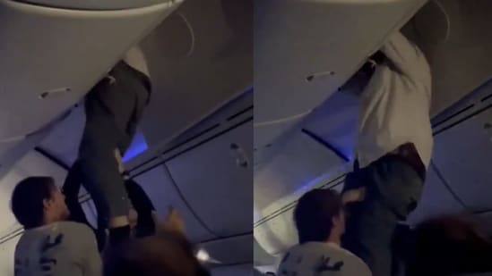 A viral video shows an Air Europa passenger being rescued from the overhead bin.(X/@aviationbrk)