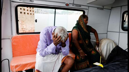 Relatives mourn outside a hospital in Hathras. (REUTERS)