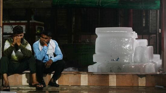 Relatives outside the morgue of a hospital in Hathras. (AFP)