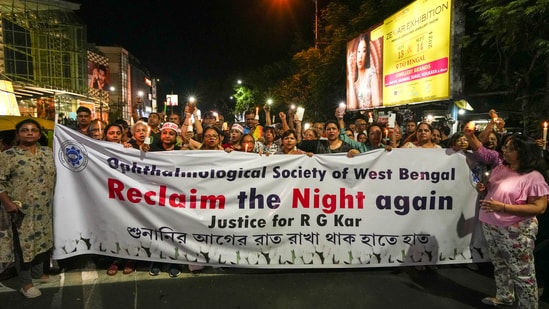 People hold banners during a candlelight march. Reclaim the night march seemed to have returned to the streets of Kolkata for the second time.(PTI)