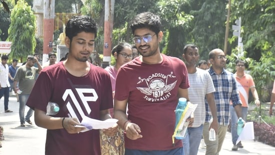 Candidates are seen discussing after appearing for the UPSC Civil Services Main Examination 2024 at College of Commerce in Patna.(Santosh Kumar)