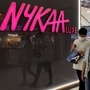 People walk past a store of Nykaa at a mall in New Delhi. (Reuters)
